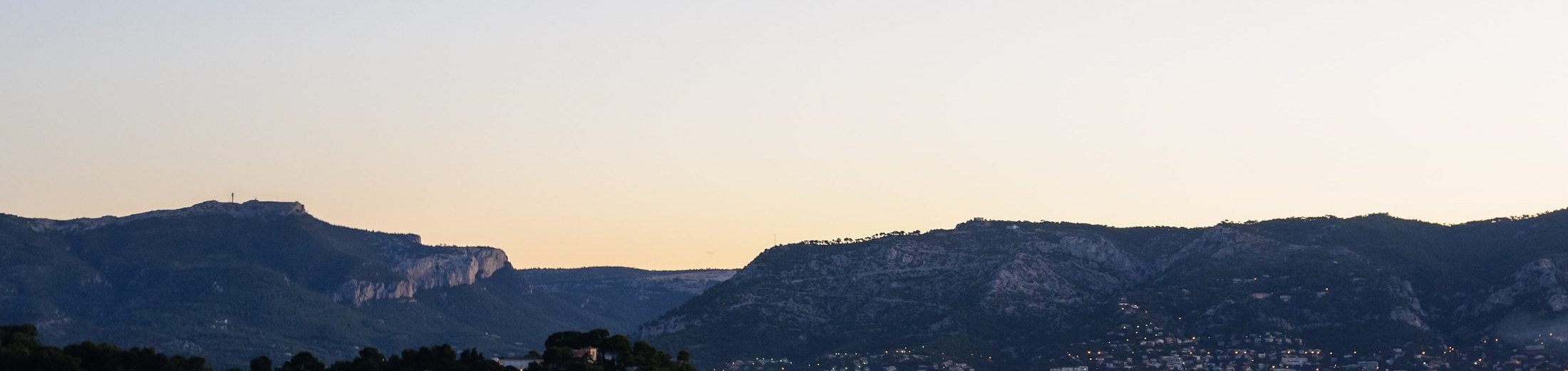 Vue large de la rade de Toulon au crépuscule, au pied du Mont Faron